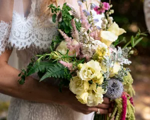 Bride hold her bouquet she created for her wedding. 