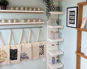 Scented candles, totes, and drink glasses