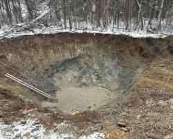 large construction hole with a ladder to get in and out